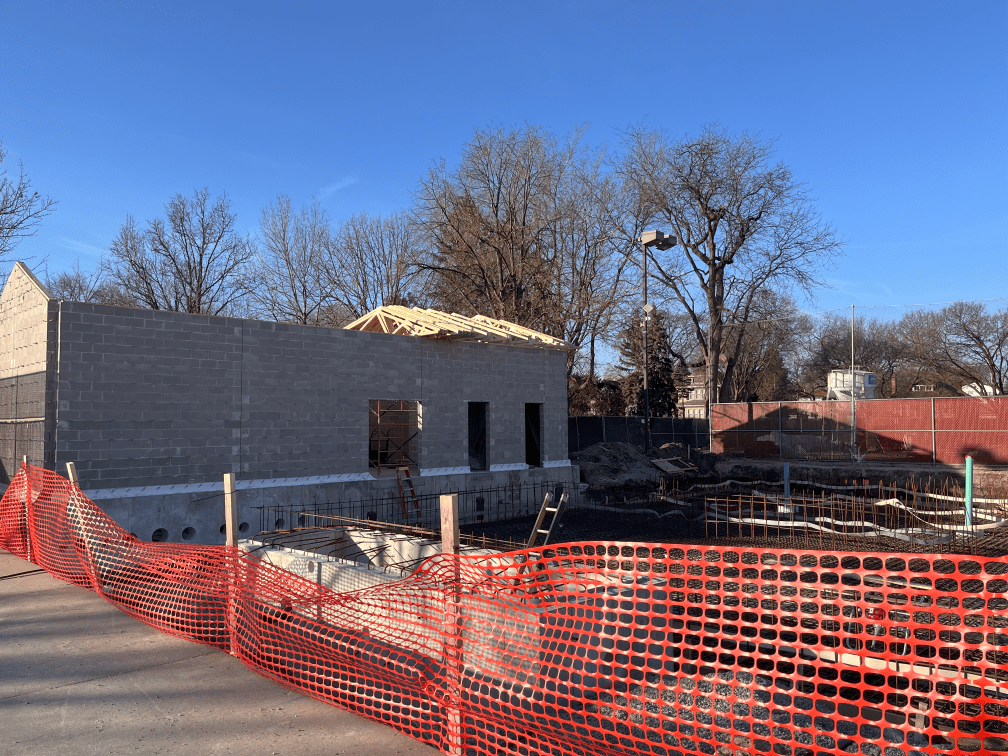 Construction of the Rehm Park & Pool pumphouse, showing cinder block walls and exposed foundation with rebar.
