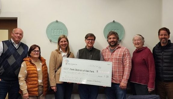 park board and foundation pose with scholarship fund donation check