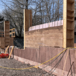 one rammed earth wall between two wood frames