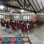 room with wood beams and chairs set up for an event