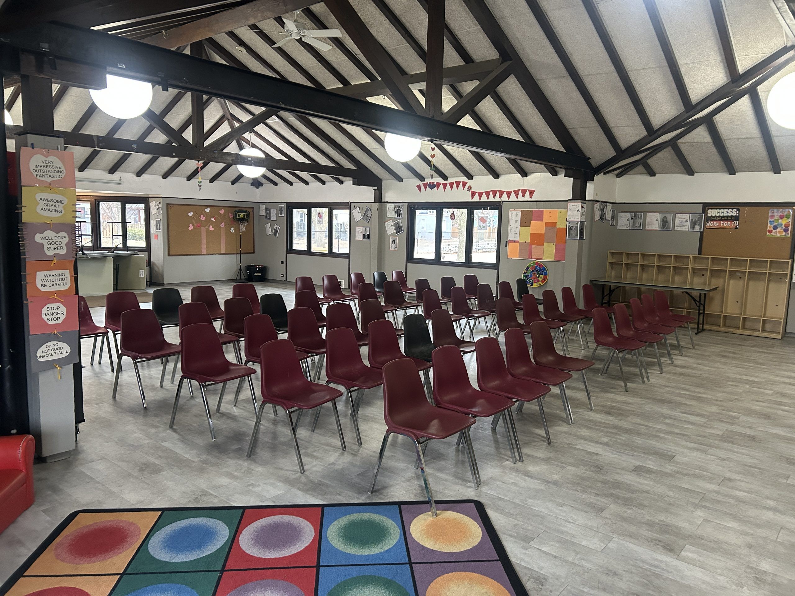 room with wood beams and chairs set up for an event