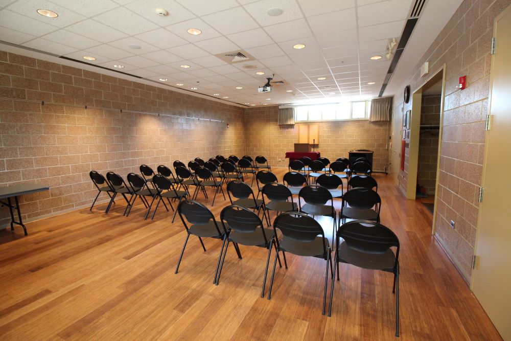 black chairs set in room with brick walls and wood floors