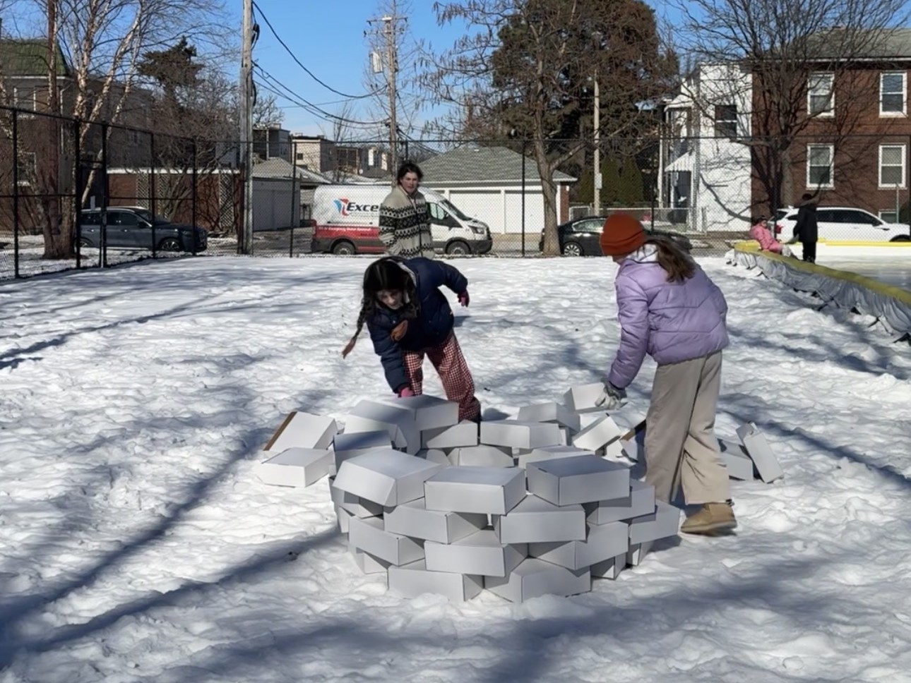 two kids build an igloo